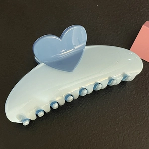 Blue heart-shaped hair claw clip for women featuring a minimalist resin shark clip design
