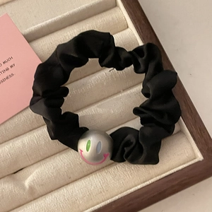 Elegant black satin scrunchie with a silver metallic smiley face bead decoration
