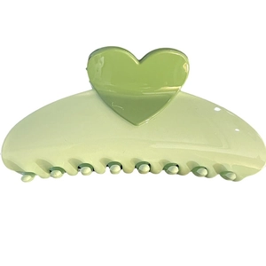 Pink heart-shaped hair claw clip with dark green accent on white background