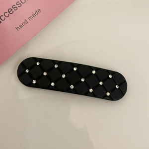 Elegant black quilted pattern hair clip with rhinestones and matte finish for women