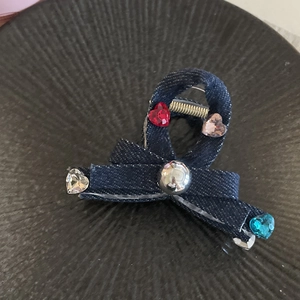 Blue denim bow hair claw clip with colorful heart rhinestones and silver bead detail