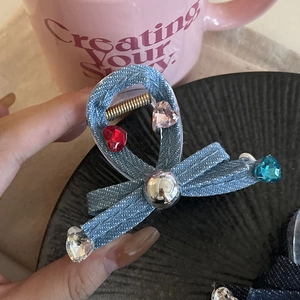 Denim bow hair claw clip with heart-shaped rhinestones and casual aesthetic