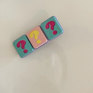 Detail of colorful question mark hair clip with matte pastel square blocks for girls