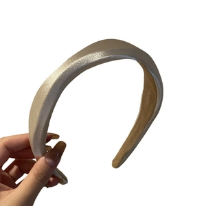 Elegant champagne satin padded headband with wavy texture and non-slip lining