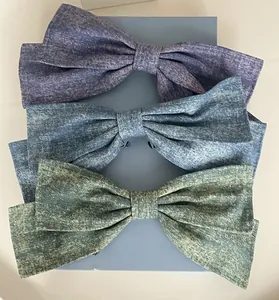 Detailed set of three oversized denim texture hair bows in purple, light blue and green