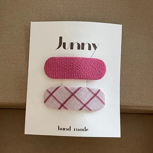Pastel pink floral and checkered fabric BB hair clips set for girls on a display card