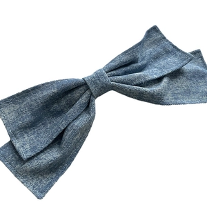 Oversized washed blue denim bow hair clip with white contrast stitching for women