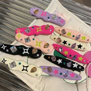 Colorful Y2K style star hair clips with rhinestones and gems in various vibrant colors