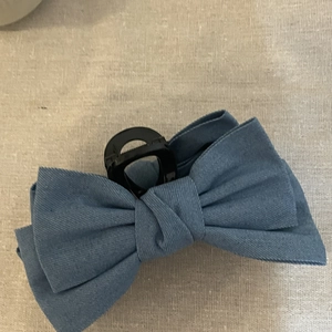 Large denim bow hair claw clip for women in blue fabric with a minimalist vintage style