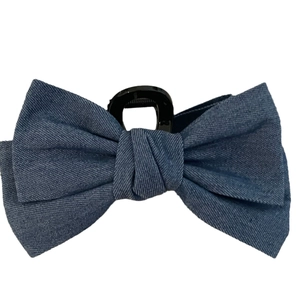 Denim bow hair claw clip for thick hair in blue fabric with a sturdy plastic shark clip base