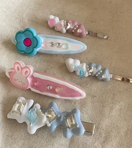Detailed view of four colorful Y2K style hair clips featuring rabbit and flower charms