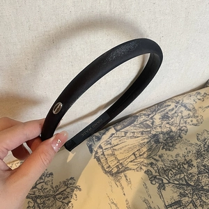 Elegant thick black satin headband with silver logo plaque and handmade label