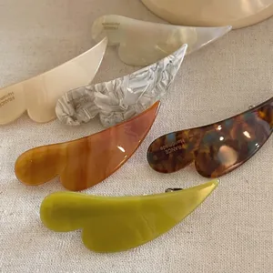 Five assorted acetate hair clips in elegant marble and tortoiseshell patterns for women