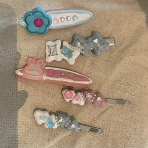 Set of five Y2K style rhinestone and pearl hair clips in pastel macaron colors