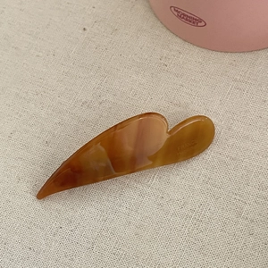 Detailed view of handmade acetate tortoise hair clip with France Handmade engraving