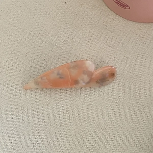 Detail of pink marble acetate hair clip with FRANCE Handmade engraving on canvas