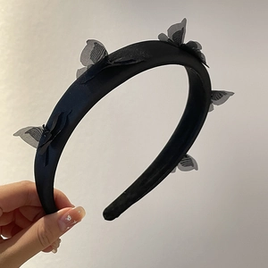 Thick black satin headband featuring five delicate translucent butterfly embellishments
