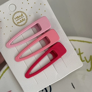 Lot de trois barrettes à cheveux rose dégradé mat présentées sur une carte cadeau