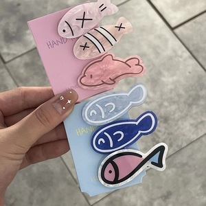 Handmade fish shaped acetate hair clips in colorful marble patterns for women