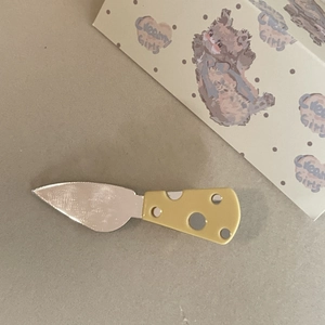 Cute cheese-inspired butter knife hair clip set with bright yellow Swiss cheese patterns