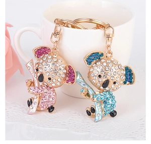 Detail of pink and blue rhinestone-studded koala keychains with gold lobster clasps