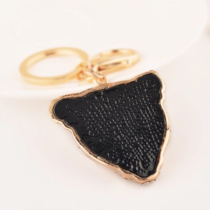 Elegant gold leopard head keychain with black texture and sparkling crystals for handbags