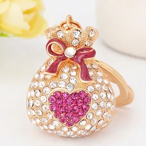 Porte-clés sac de chance en alliage avec cœur en cristal rose et nœud rouge chic