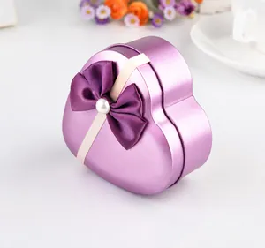 Detail of a purple heart-shaped gift box with a matte finish and a pearl satin bow