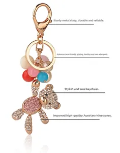 Detail of golden bear keychain with sparkling crystals and colorful translucent beads