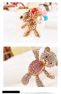 Close-up of bear-shaped keychain with gold heart frame and colorful faux pearls