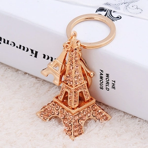 Porte-clés Tour Eiffel doré avec strass jaunes et petit pendentif sur peluche