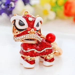 Macro shot of traditional Chinese dancing lion keychain with red enamel and crystals