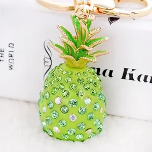 Detailed macro view of a sparkling pineapple keychain with green rhinestones and gold ring