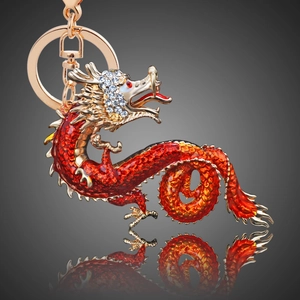 Macro view of Chinese dragon keychain with red enamel and white crystal accents