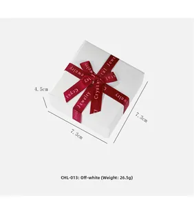 Creamy white jewelry gift box with red silk ribbon and size dimensions 7.3x7.3x4.5cm