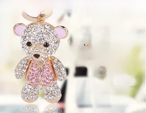 Detail of cute teddy bear keychain with pink and white crystal rhinestones and gold plating