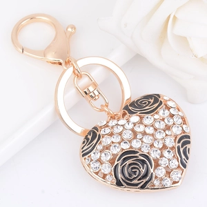 Portachiavi a cuore dorato scintillante con strass e fiori di rosa in smalto nero