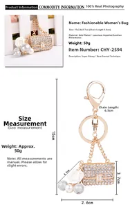Detailed view of gold mini bag keychain with white rose pearls and crystal rhinestones