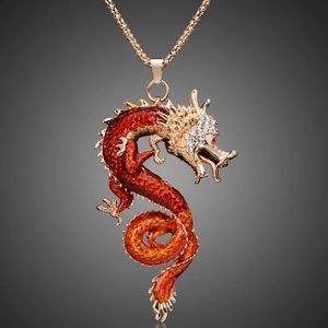 Close-up of golden dragon keychain with red gradient enamel and sparkling crystal details