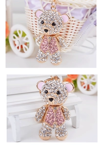 Detailed close-up of a pink and white rhinestone teddy bear keychain with gold plating