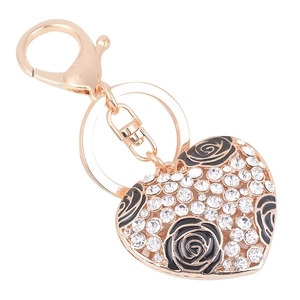 Portachiavi a cuore oro rosa con strass e rose in smalto nero su sfondo bianco