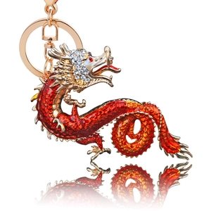 Detailed macro view of golden dragon keychain with red enamel and white rhinestones