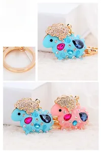 Detail of cartoon sheep keychain featuring colorful crystals and golden alloy hardware