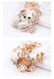 Detailed front and back view of crystal crab keychain with heart rhinestone and gold plating