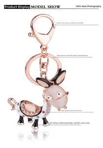 Detailed view of donkey keychain with cat eye stone, rose gold plating and rhinestones