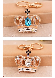 Exquisite crystal crown keychains with blue and clear rhinestones on a jewelry box
