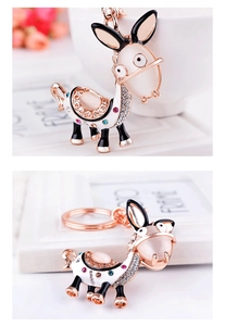Detailed view of rose gold donkey keychain with cat-eye stone and crystal accents