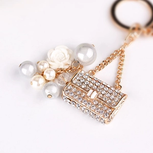 Elegant pearl handbag keychain with crystal rhinestones and camellia flower charm