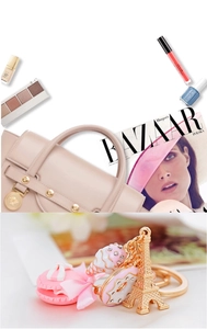 Detailed close-up of pink macaron and Eiffel Tower pendant on a golden metal keychain