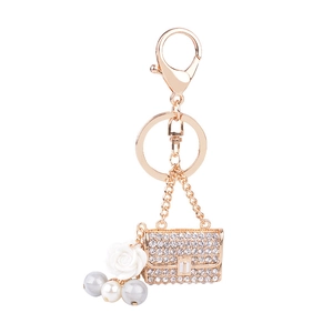 Elegant rose gold alloy pearl keychain featuring white camellia flower and rhinestone bag charm